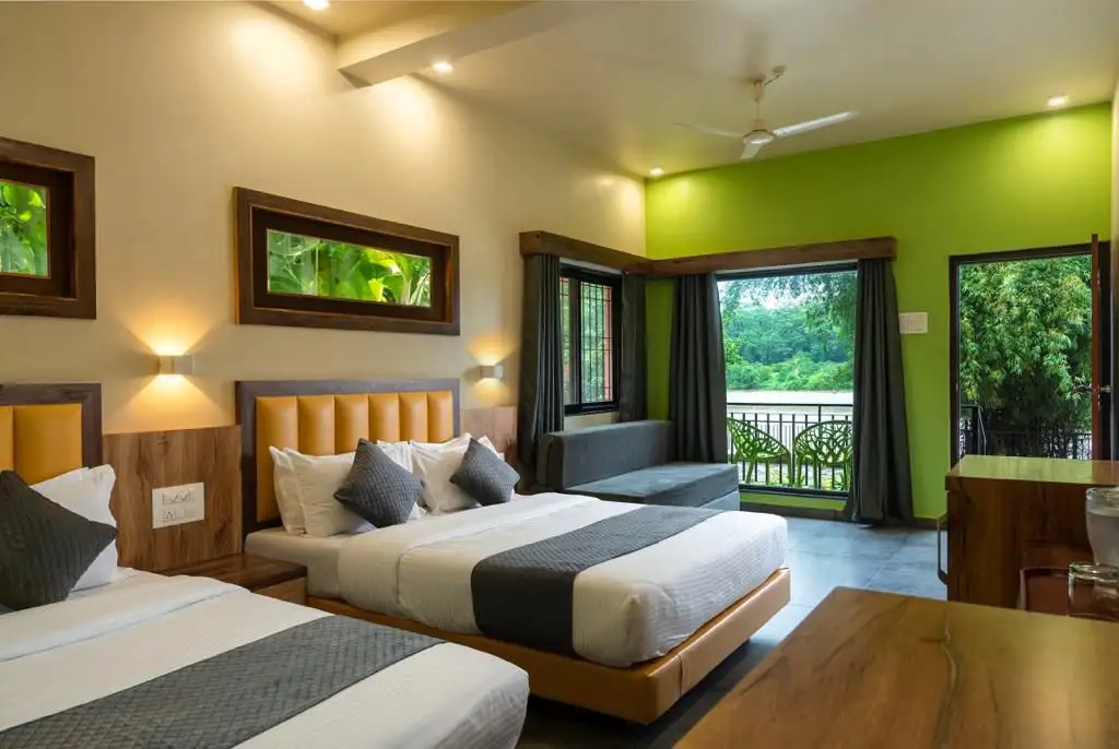 Spacious AC Deluxe room interior at River Edge Retreat Dandeli