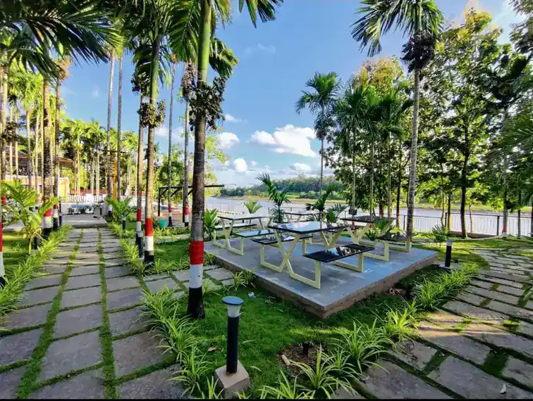 Riverside seating with sunset view at River Edge Retreat Dandeli